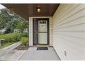 Welcoming front entryway with a decorative glass-accented door and neutral siding at 2008 Tweed Ct, Leesburg, FL 34788