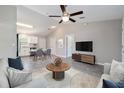 Open-concept living room and dining area with vaulted ceilings, ceiling fan, and neutral décor at 20443 Sw Rainbow Lakes Blvd, Dunnellon, FL 34431