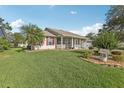Charming home with a well-kept lawn and vibrant, mature landscaping at 2208 Orkney Dr, Leesburg, FL 34788
