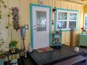 Charming front porch with decorative door, plants, and ornate accents, creating a warm and welcoming entrance at 22736 Sw 117Th St, Dunnellon, FL 34431