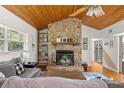 Living room with vaulted ceilings and stone fireplace at 2475 Sw 7Th Ave, Ocala, FL 34471