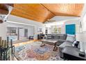 Living room with vaulted wood ceilings and sliding glass doors to the pool at 2475 Sw 7Th Ave, Ocala, FL 34471