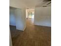 View of the living room with tile floors and a sliding door leading to the backyard at 3740 Ne 5Th St, Ocala, FL 34470