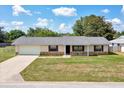 Charming single-story home featuring stone accents, a well-maintained lawn, and an attached one-car garage at 4331 Se 106Th Pl, Belleview, FL 34420