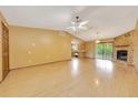Open-concept living room boasts wood floors, fireplace, and natural light at 4331 Se 106Th Pl, Belleview, FL 34420