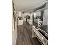 Spacious kitchen with granite countertops, island, white cabinets, and stainless appliances at 4520 Se 28Th St, Ocala, FL 34480