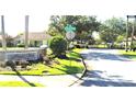 Community entrance featuring a stone sign surrounded by manicured landscaping and gated access at 4990 Sw 63Rd Loop, Ocala, FL 34474