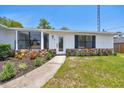 Inviting front entrance with well-manicured landscaping and stone accents at 6 Bahia Circle Loop, Ocala, FL 34472