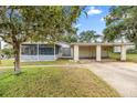 Lovely single-Gathering home showcasing a screened porch and convenient carport at 705 Washington Ave, Eustis, FL 32726