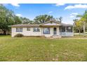 Charming single-story home with a screened-in porch and well-maintained lawn at 705 Washington Ave, Eustis, FL 32726