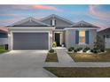 Charming single-story home with a gray exterior, blue shutters, and a well-manicured front yard at 7571 Sw 64Th Street Rd, Ocala, FL 34474
