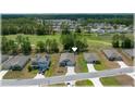 An aerial view of a single Gathering homes nestled within a community, backing onto a lush green space and a golf course at 96 Hickory Crse, Ocala, FL 34472
