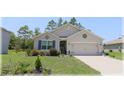 Charming single Gathering home with a well-maintained front yard and two car garage at 96 Hickory Crse, Ocala, FL 34472