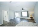 Bright living room with modern flooring, ceiling fan, and natural light at 10523 Sw 62Nd Terrace Rd, Ocala, FL 34476