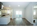 Open-concept living space with sliding doors and modern floors; lots of natural light at 10523 Sw 62Nd Terrace Rd, Ocala, FL 34476