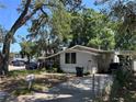 Charming home exterior with covered carport and established trees at 119 Lockhart St, Daytona Beach, FL 32114