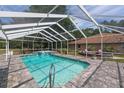 Screened in pool featuring a hot tub and clear blue water at 12495 Sw 66Th St, Ocala, FL 34481