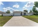 Beautiful single-story home with a spacious driveway, two-car garage, and fenced yard at 14055 Sw 30Th Terrace Rd, Ocala, FL 34473