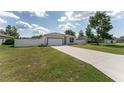 Attractive single-story home with a two-car garage, well-maintained lawn, and fenced yard at 14055 Sw 30Th Terrace Rd, Ocala, FL 34473