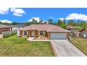 Inviting single-story home with a well-maintained front yard and an attached two-car garage at 16969 Sw 40Th Cir, Ocala, FL 34473