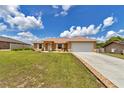 Beautiful single-story home with a lush lawn and a two car garage on a sunny day at 16969 Sw 40Th Cir, Ocala, FL 34473