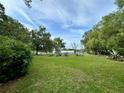 Sprawling backyard, framed by mature trees, provides a serene and private outdoor space perfect for recreation and relaxation at 2409 Nw 7Th St, Ocala, FL 34475