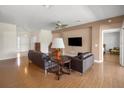 Inviting living room with wood floors, a ceiling fan, and comfortable couches, perfect for relaxing and entertaining at 4225 Sw 57Th Ave, Ocala, FL 34474