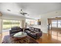 Cozy living room with plush couches, ceiling fan and large sliding glass doors to the patio at 4225 Sw 57Th Ave, Ocala, FL 34474