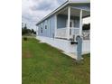 Inviting cottage with cozy porch, framed by green lawn and neat landscaping in a peaceful setting at 4345 Nw 27Th Pl, Ocala, FL 34482
