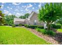Landscaped front yard with a brick home, lush green grass, and manicured shrubbery at 4812 Se 12Th Pl, Ocala, FL 34471