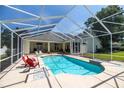 Inviting screened-in pool area with lounge chairs, perfect for relaxation and outdoor entertainment at 4812 Se 12Th Pl, Ocala, FL 34471
