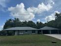 This home boasts a spacious attached carport, offering ample parking and protection from the elements at 4911 Se 135Th Pl, Summerfield, FL 34491