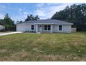 Inviting single-story home with a well-maintained lawn and attached single-car garage at 541 56Th Ct, Ocala, FL 34482