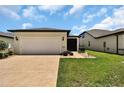 Well-maintained home featuring an attached two-car garage and a screened-in porch at 6051 Sw 93Rd Cir, Ocala, FL 34481