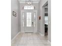 Inviting foyer with decorative front door and tile floors at 7210 Sw 179 Ct, Dunnellon, FL 34432