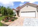 Beautiful home exterior showcasing a two-car garage and brick-paved driveway at 7210 Sw 179 Ct, Dunnellon, FL 34432