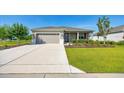 Charming single-story home featuring a well-manicured lawn, a two-car garage, and a welcoming front entrance at 7750 Sw 87Th Ave, Ocala, FL 34481
