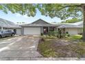 Home with a 2-car garage, covered porch, and a well-maintained lawn and landscaping at 8745 Sw 92Nd St # B, Ocala, FL 34481