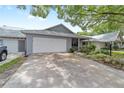 Home with a 2-car garage, covered porch, and a well-maintained lawn and landscaping at 8745 Sw 92Nd St # B, Ocala, FL 34481