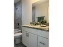 Bathroom features a shower-tub, a granite countertop, and modern hardware and fixtures at 960 Nw Redwood Dr, Dunnellon, FL 34431