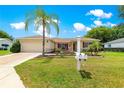 Inviting single-story home with a lush lawn, decorative landscaping, and a convenient mailbox at 9891 Se 138Th Loop, Summerfield, FL 34491