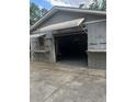 A detached garage featuring an awning and visible shelving at 1101 Se 33Rd Ave, Ocala, FL 34471