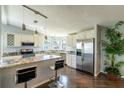 Modern kitchen featuring granite countertops, stainless steel appliances, and an island with breakfast bar at 1228 Maria Ct, Lady Lake, FL 32159