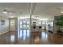Bright open-concept living area featuring hardwood floors, modern kitchen, and plenty of natural light at 1228 Maria Ct, Lady Lake, FL 32159