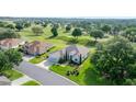Desirable single-story home on golf course featuring lush landscaping and an attached two-car garage at 13015 Se 93Rd Cir, Summerfield, FL 34491