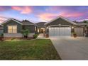 Charming home with a well-manicured lawn, neutral paint colors, and a convenient two-car garage at 13495 Se 93Rd Court Rd, Summerfield, FL 34491