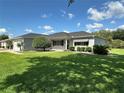 Charming single-story home featuring a well-manicured lawn, mature landscaping, and attached two-car garage at 14117 Sw 115Th Cir, Dunnellon, FL 34432