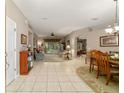 Open-concept living and dining area with tile floors and lots of natural light at 18328 Sw 73Rd Loop, Dunnellon, FL 34432