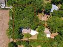 Aerial view showcasing the property's lot size, including the home, garage, and surrounding trees at 200 Se 145Th St, Summerfield, FL 34491