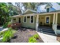 Side exterior view with brick accents and well-maintained landscaping at 20549 9Th St, Mc Intosh, FL 32664